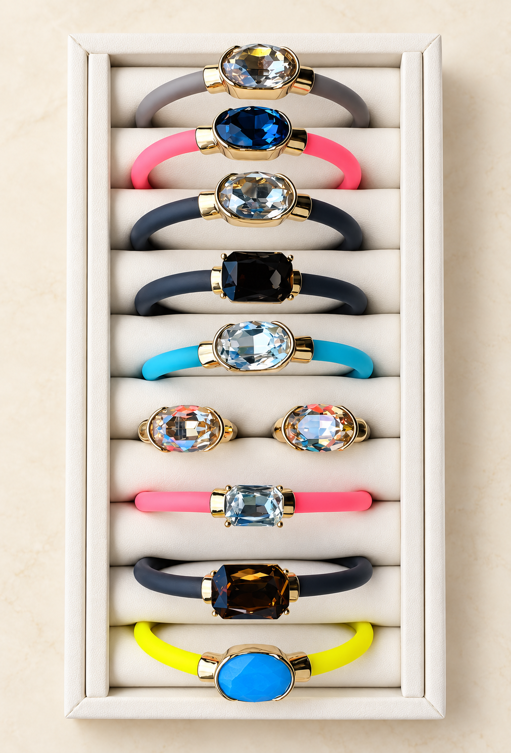 Full Color Pop gemstone bracelet and ring collection on an ivory display